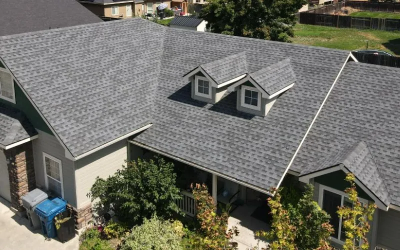 Front top view of a home in Evansville WI with a new roof installed by rooster roofing. Grey shingles and two small windows on top